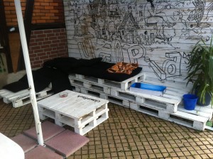 Pallet bench - seating area with table, outdoor and upholstered with pillows